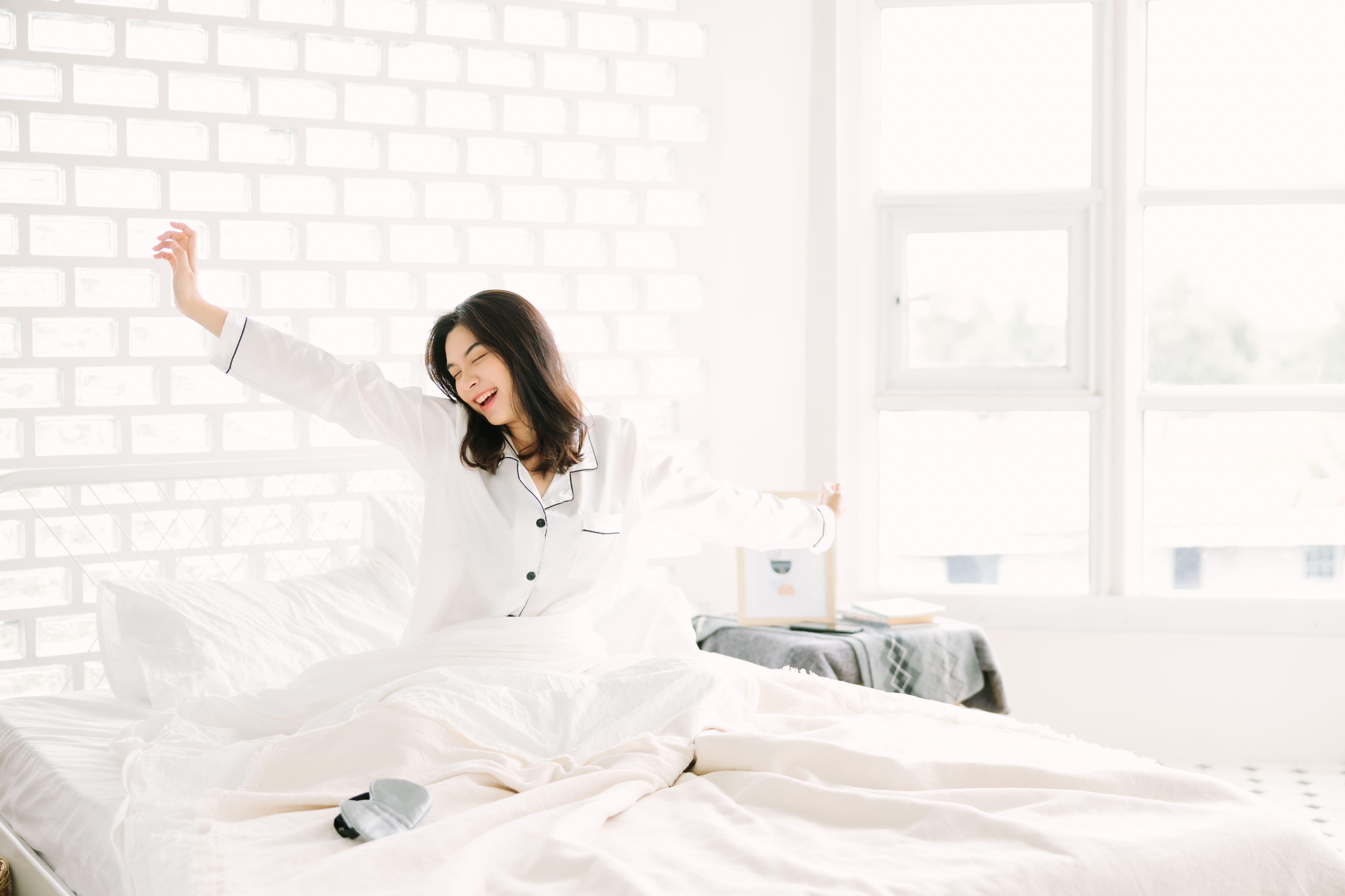 cute-asian-woman-wearing-pajamas-is-stretching-bed-home-wakes-up-morning-good-sleep (1)