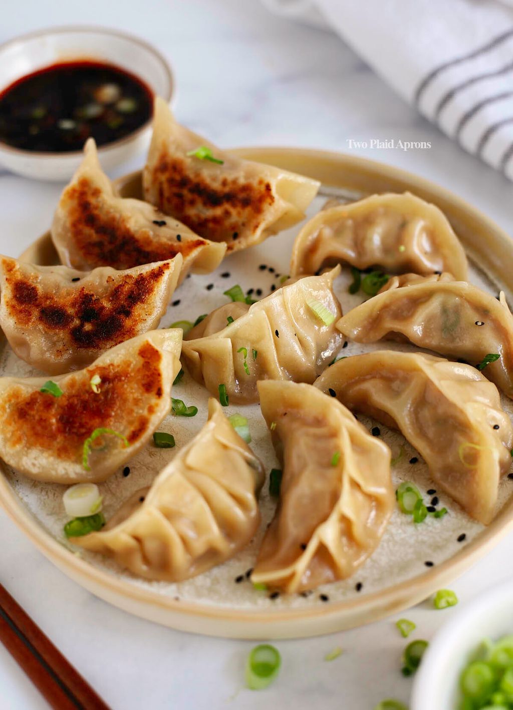 Chinese-pork-dumplings-picking-up-a-dumpling-with-chopsticks