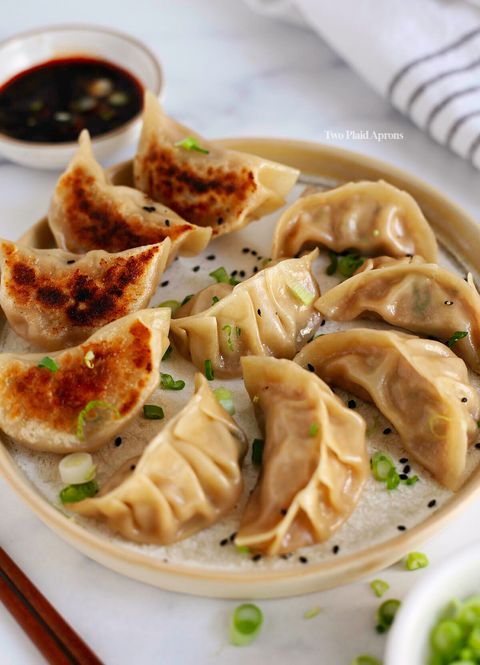 Chinese-pork-dumplings-picking-up-a-dumpling-with-chopsticks