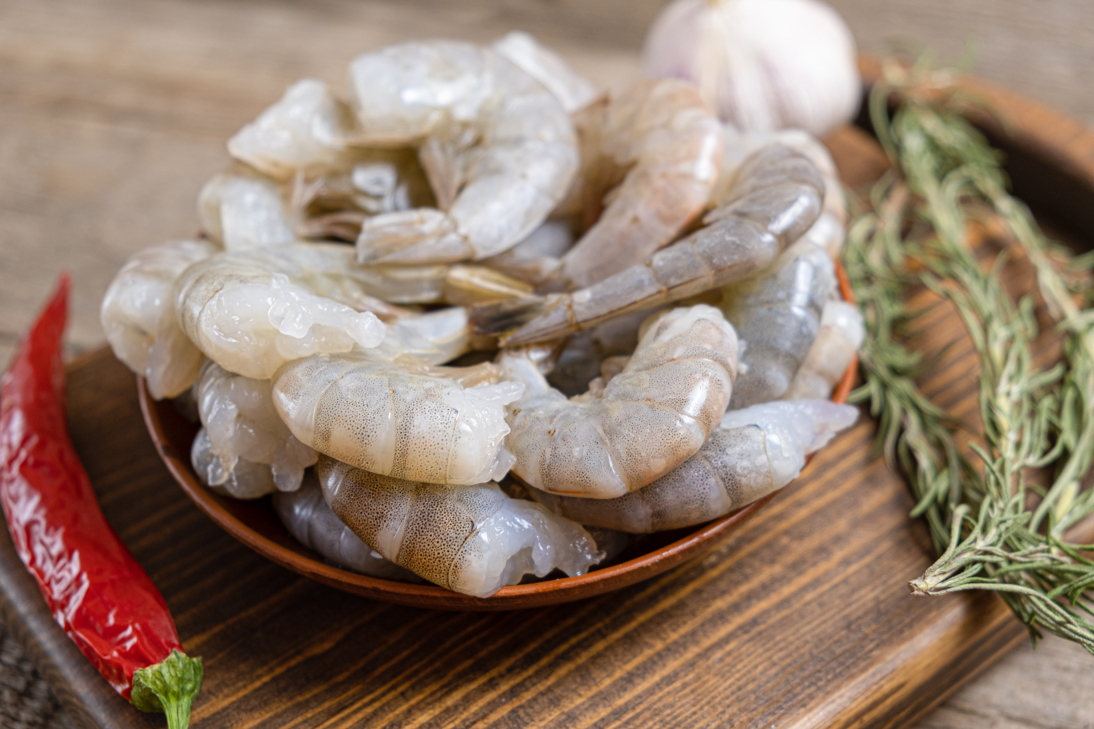 close-up-raw-shrimps-wooden-background