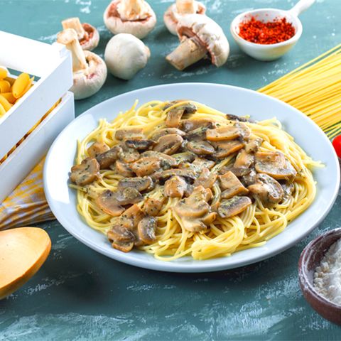 spaghetti-mushroom-with-raw-pasta-tomato-flour-spice-wooden-spoon-plate-1
