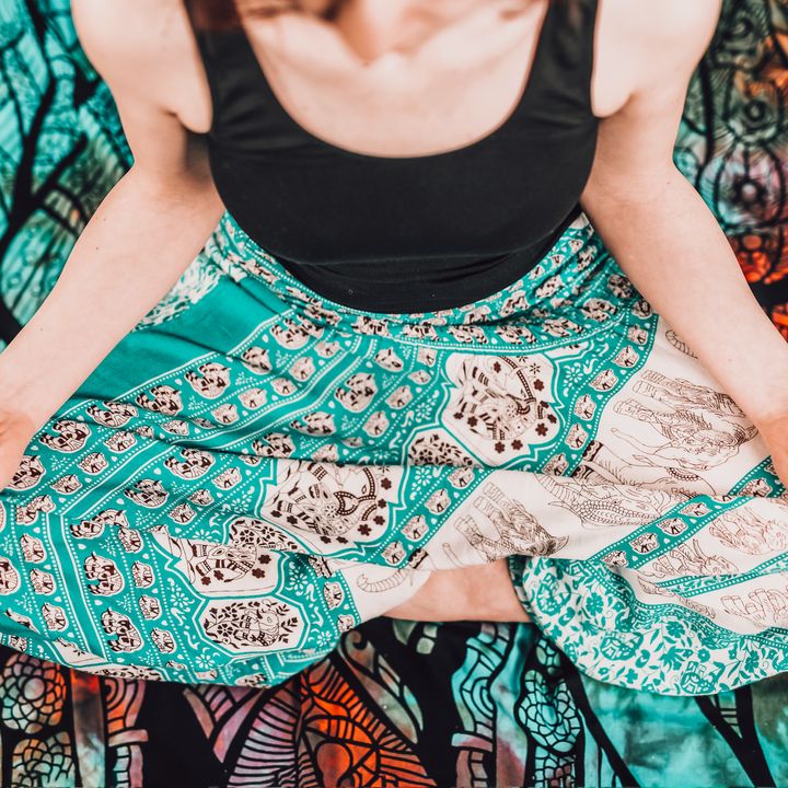 low-section-woman-sitting-lotus-pose-with-mudra-gesture-blanket