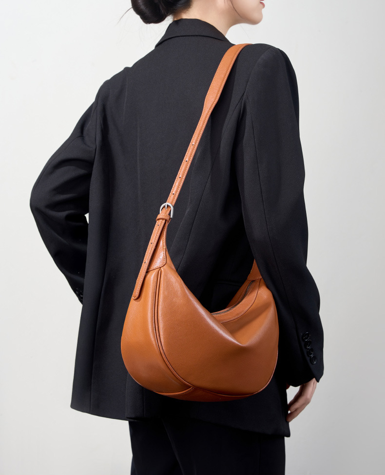 Model carrying Luna Leather Hobo Bag in Caramel – on shoulder