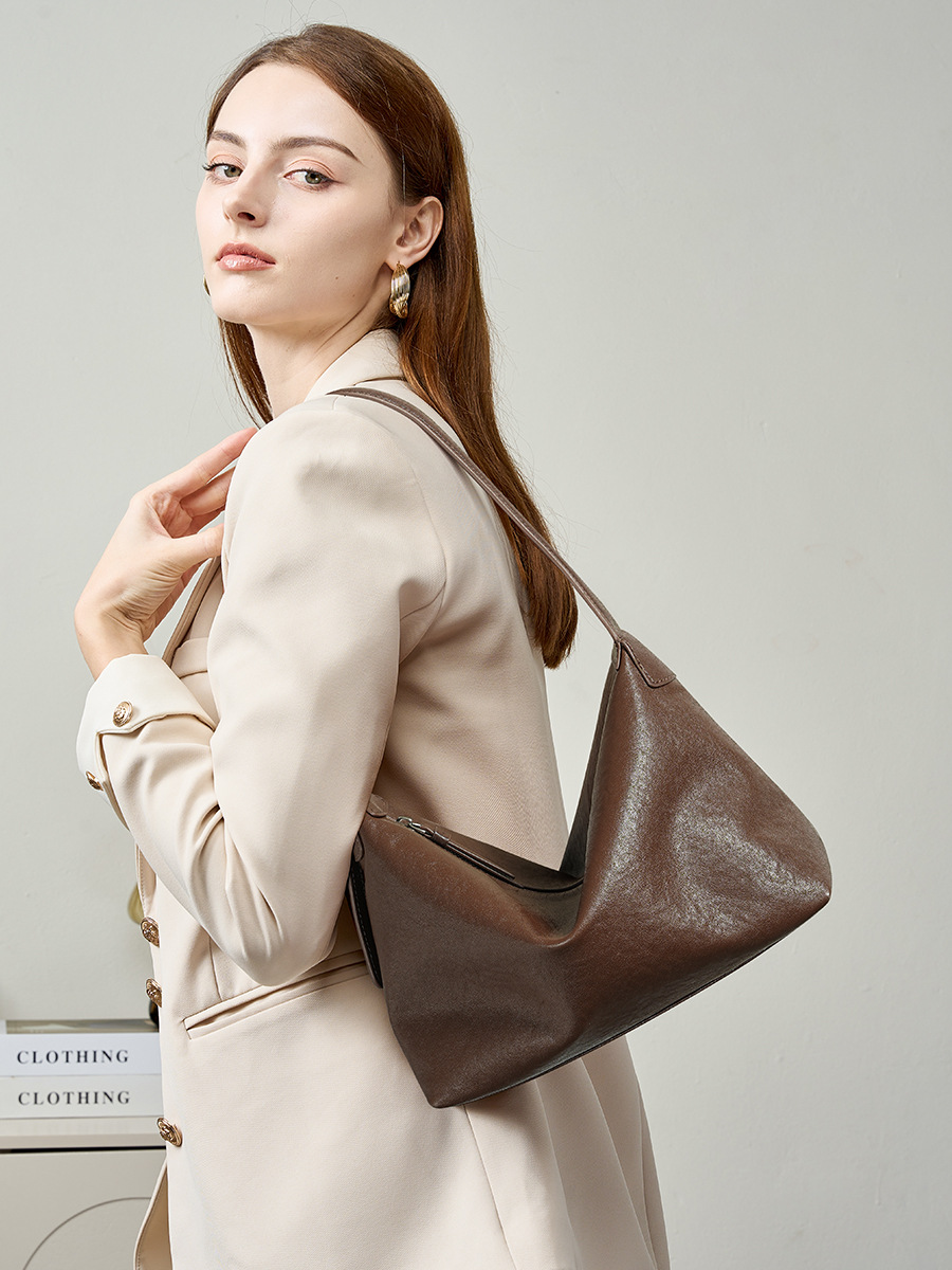 Model carrying Classic Leather Hobo Bag in Baroque Brown – on shoulder