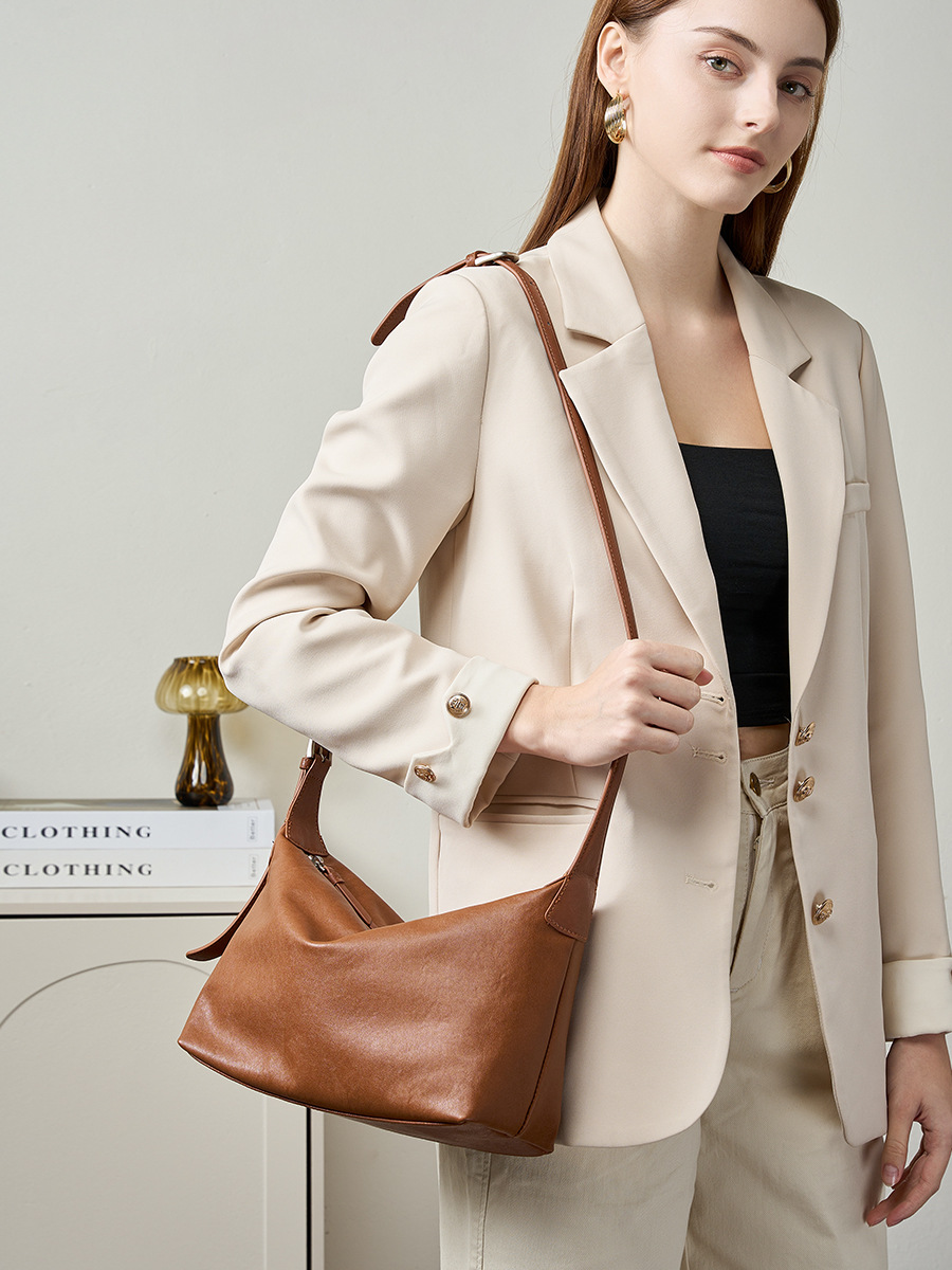 Model carrying Classic Leather Hobo Bag in Walnut – on shoulder