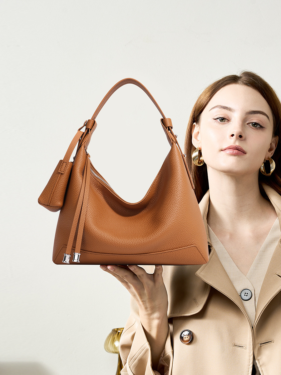 Model showcasing Chic Luxury Leather Hobo Bag in Golden Brown