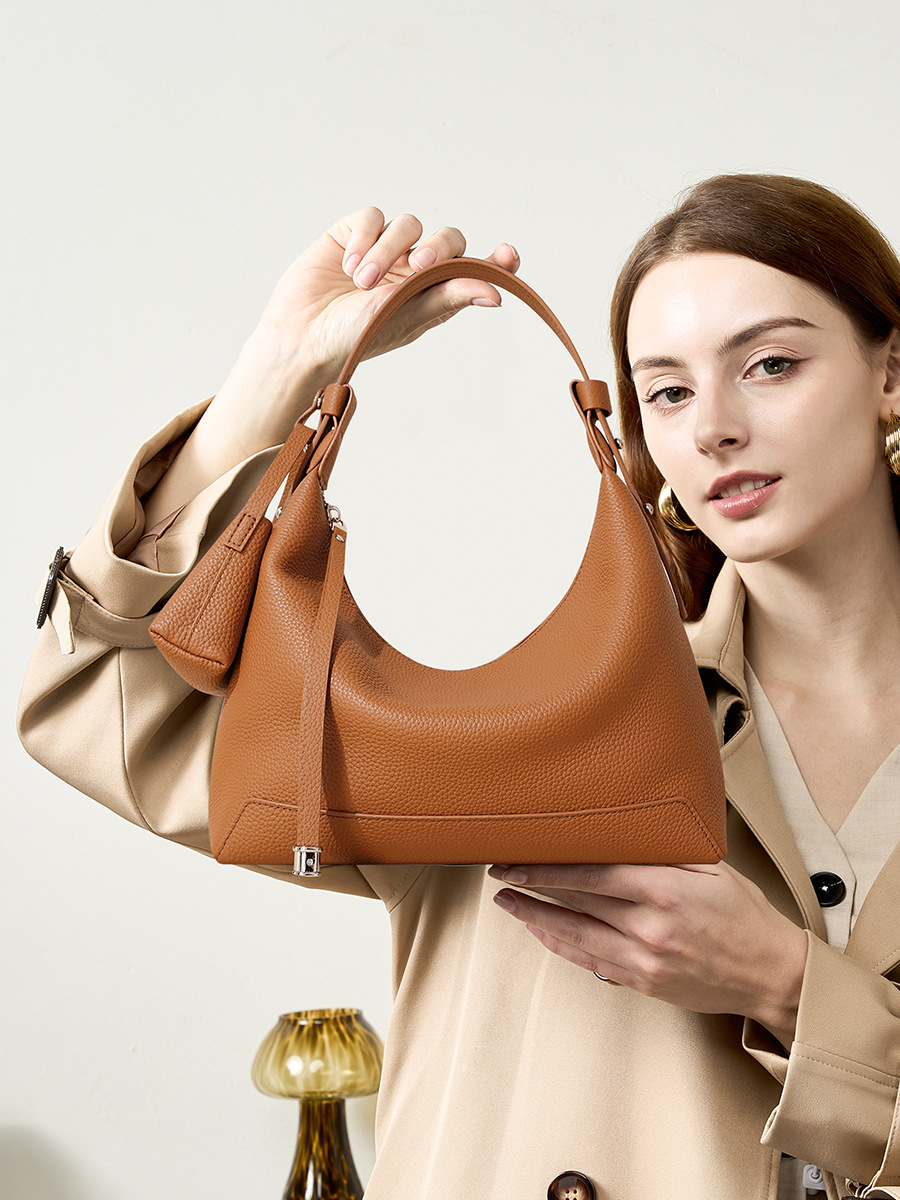 Model holding Chic Luxury Leather Hobo Bag in Golden Brown