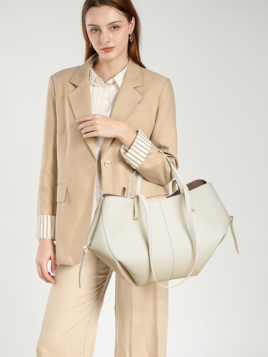 Model carrying Urban Commuter Leather Tote Bag in White – carried in crook of arm