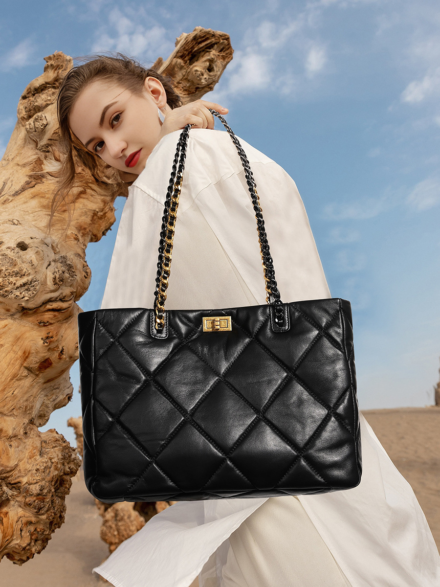 Model showcasing Elegant Quilted Leather Chain Tote Bag in Black