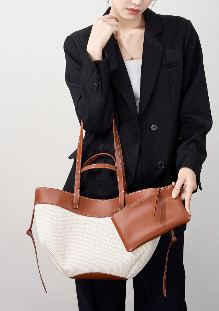 Model showcasing Wing Curve Leather Tote Bag in Brown