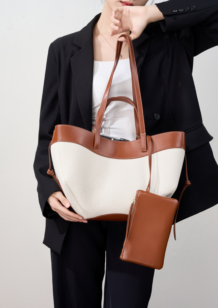 Model showcasing Wing Curve Leather Tote Bag in Brown