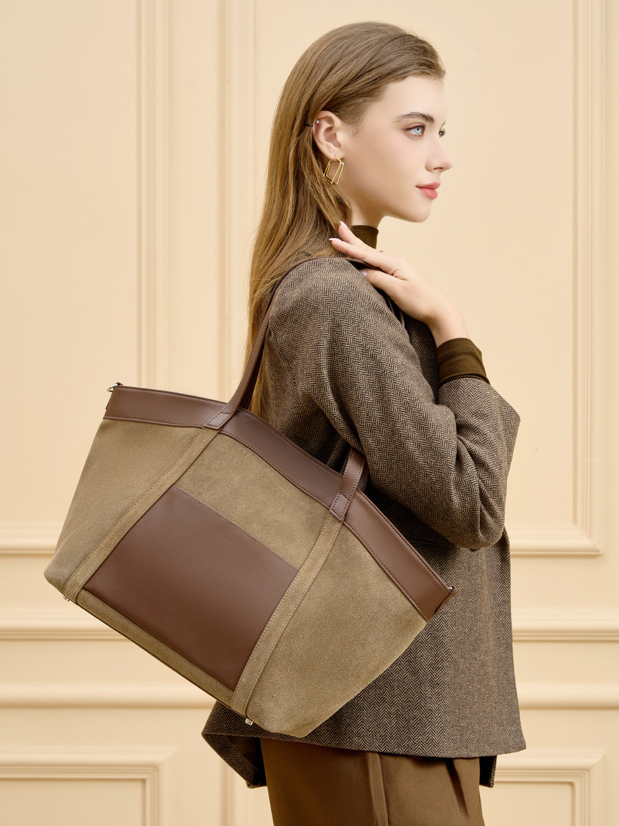 Model carrying Suede Leather Retro Tote Bag in Khaki