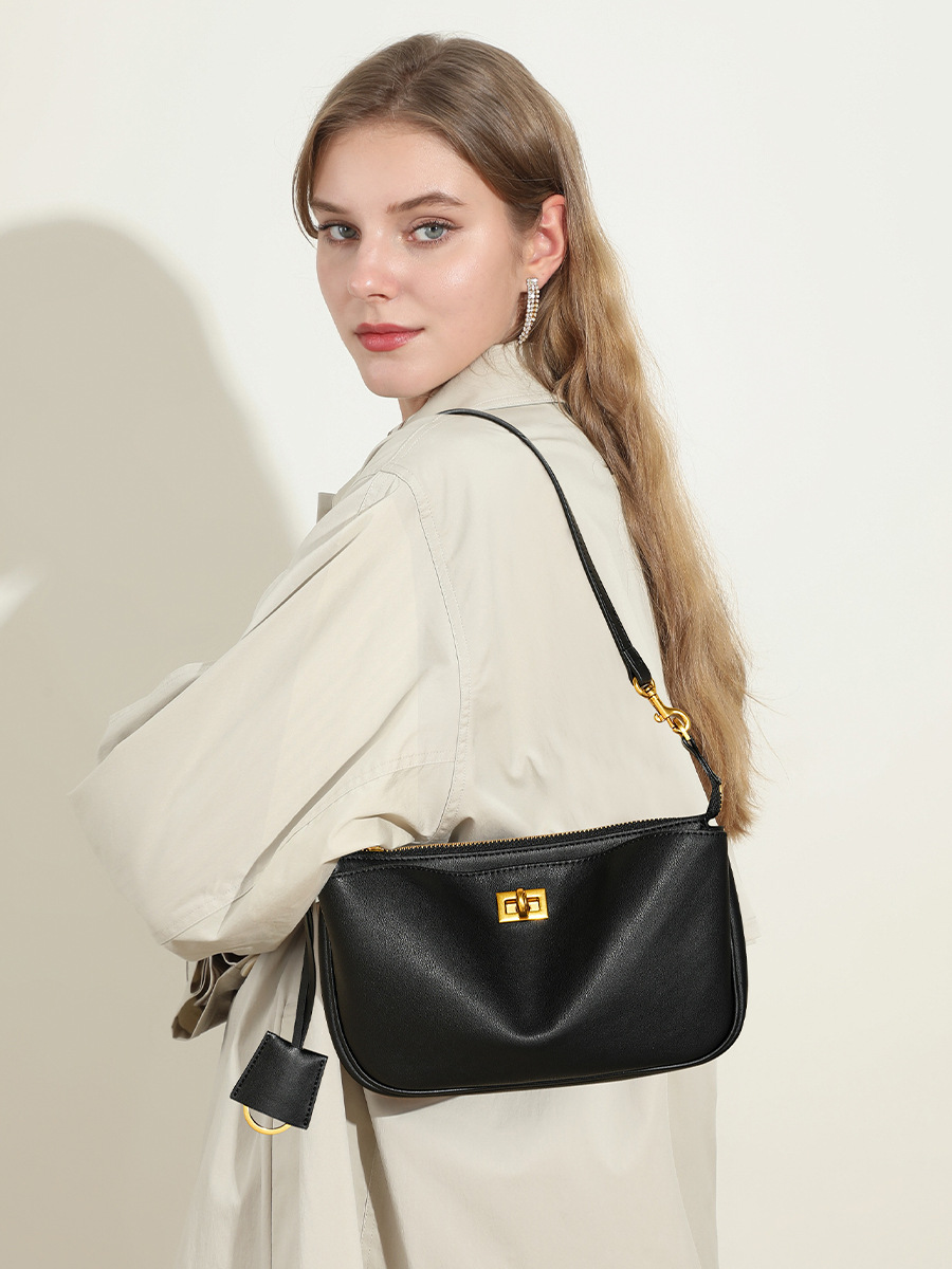 Model carrying Rodeo Leather Baguette Bag in Black