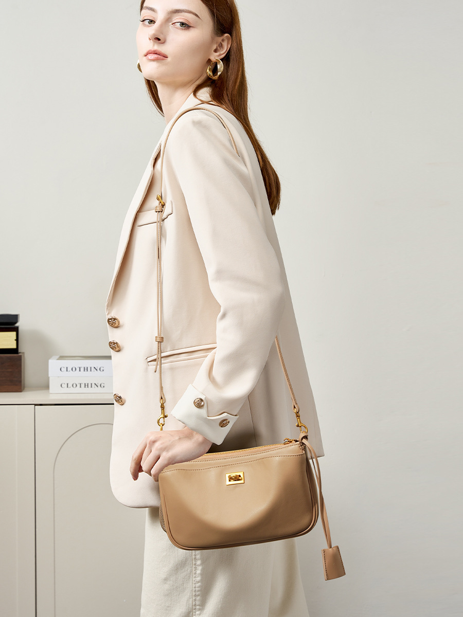 Model carrying Rodeo Leather Baguette Bag in Khaki