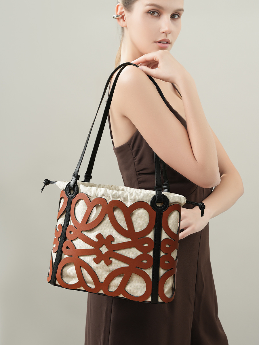 Model carrying Premium Leather Cut-Out Tote Bag in Brown – on shoulder