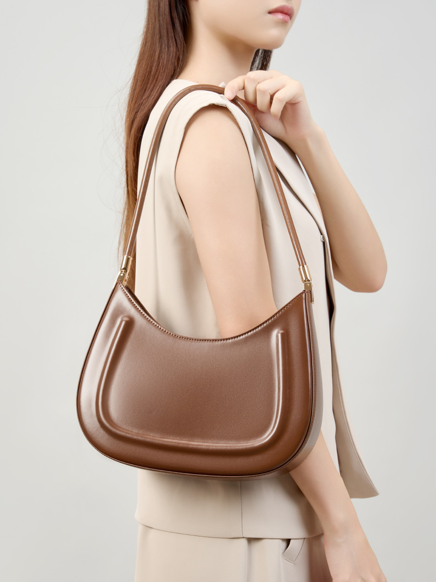 Model showcasing Oil Waxed Leather Minimalist Half Moon Bag in Caramel