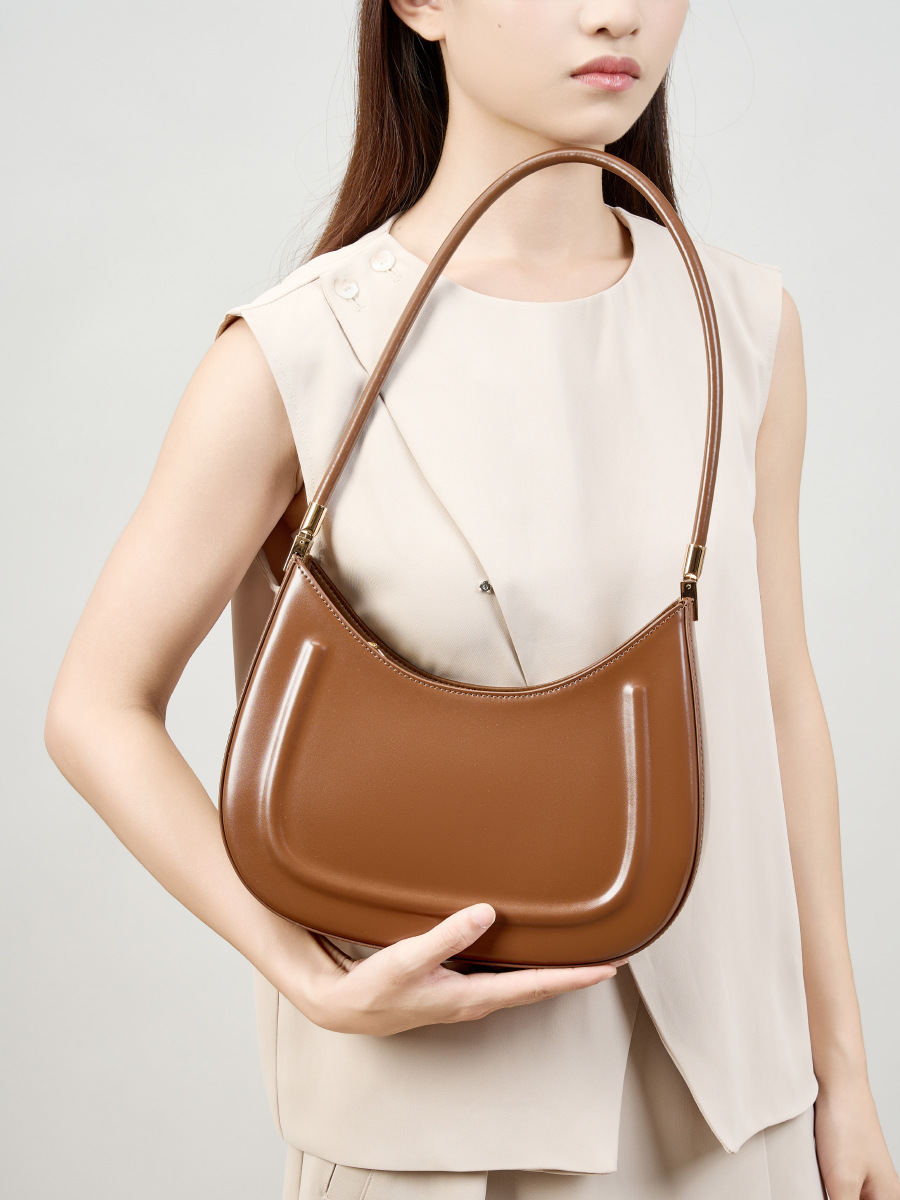 Model showcasing Oil Waxed Leather Minimalist Half Moon Bag in Caramel
