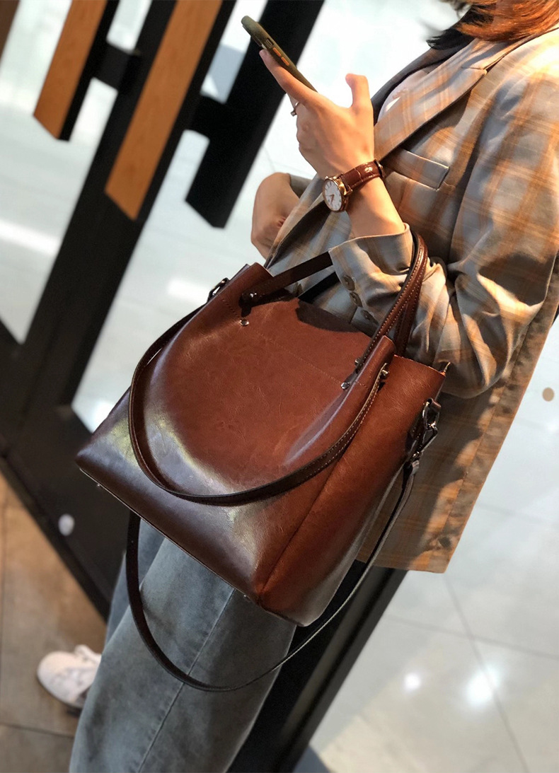 Model carrying Elegant Oil Waxed Leather Top Handle Tote Bag in Coffee