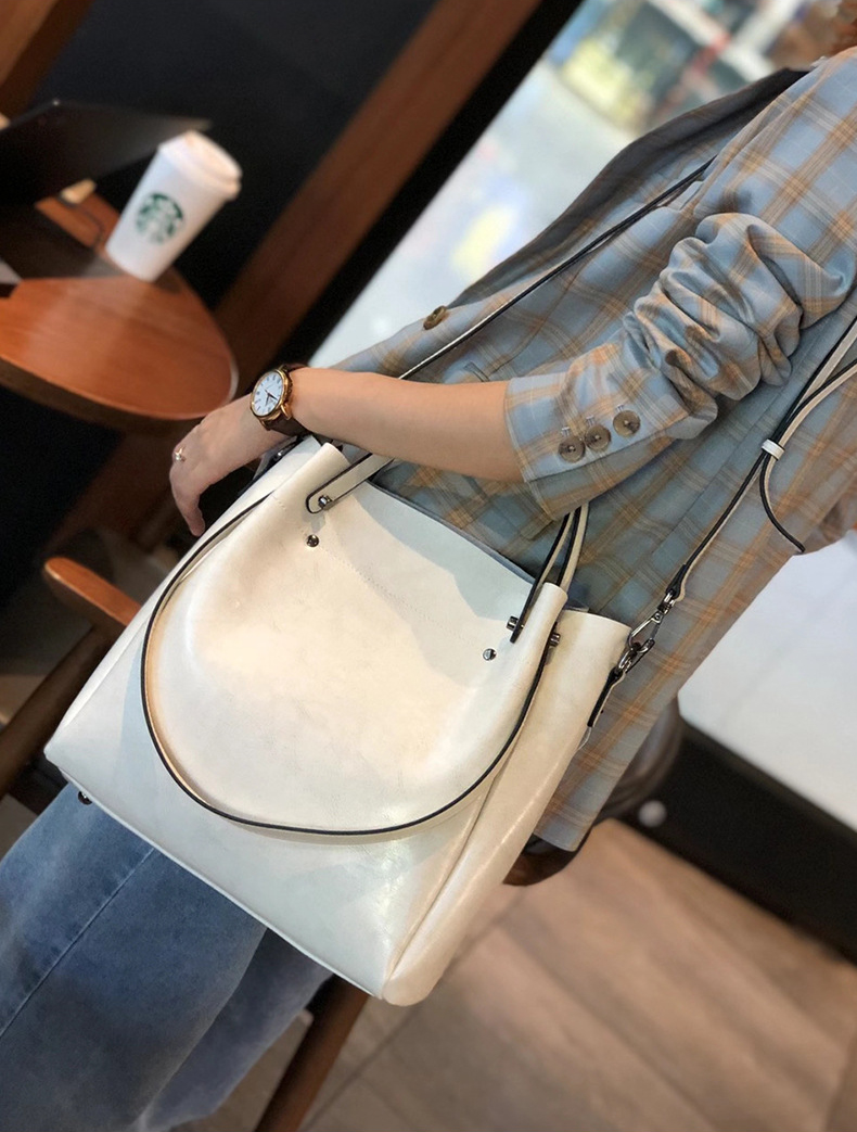 Model carrying Elegant Oil Waxed Leather Top Handle Tote Bag in White