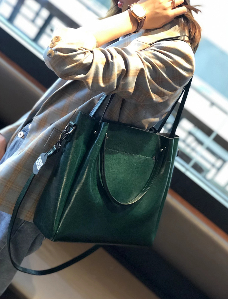 Model carrying Elegant Oil Waxed Leather Top Handle Tote Bag in Fruit Green