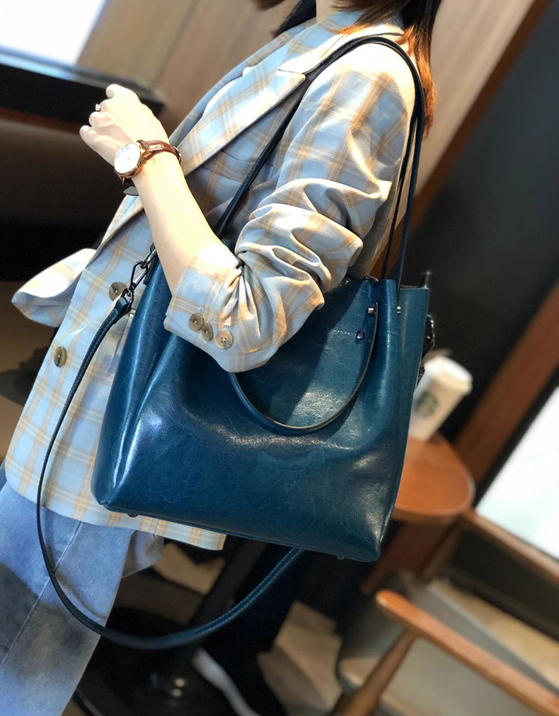 Model carrying Elegant Oil Waxed Leather Top Handle Tote Bag in Peacock Blue