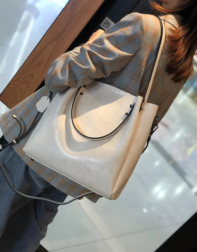 Model carrying Elegant Oil Waxed Leather Top Handle Tote Bag in White