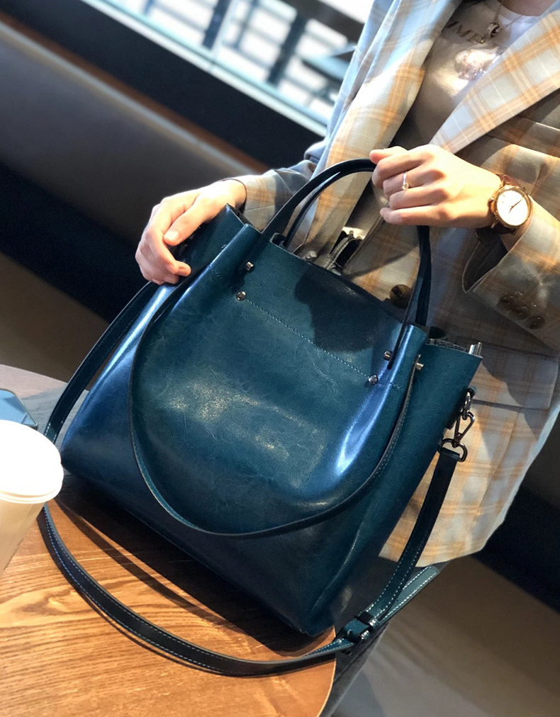Model carrying Elegant Oil Waxed Leather Top Handle Tote Bag in Peacock Blue
