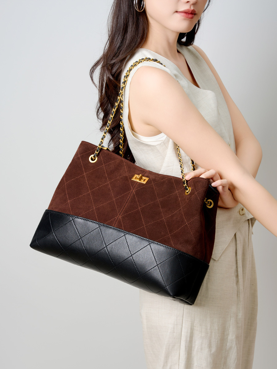 Model showcasing Premium Genuine Leather Two-Tone Chain Bucket Bag in Coffee