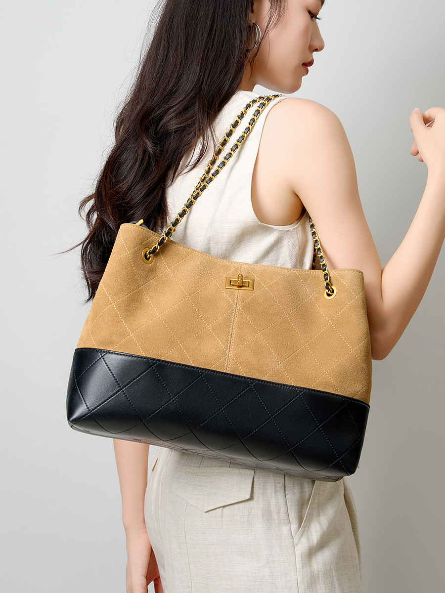 Model showcasing Premium Genuine Leather Two-Tone Chain Bucket Bag in Brown