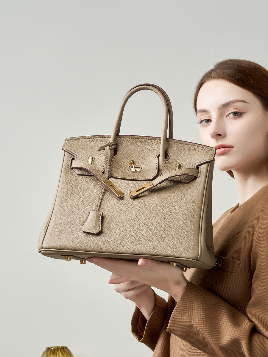Model showcasing Premium Togo Leather Structured Top Handle Bag in Khaki