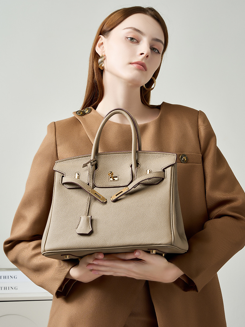 Model showcasing Premium Togo Leather Structured Top Handle Bag in Khaki