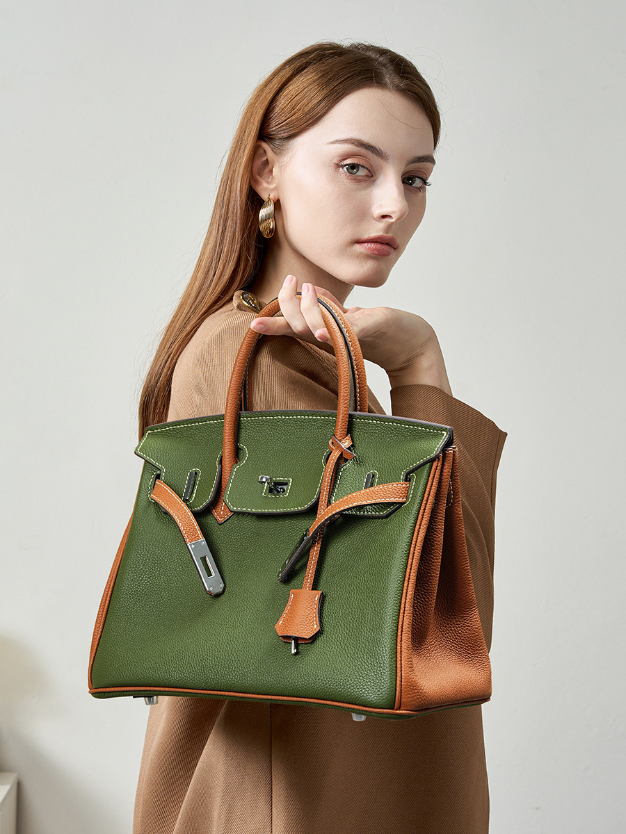 Model showcasing Premium Togo Leather Structured Two-Tone Top Handle Bag
