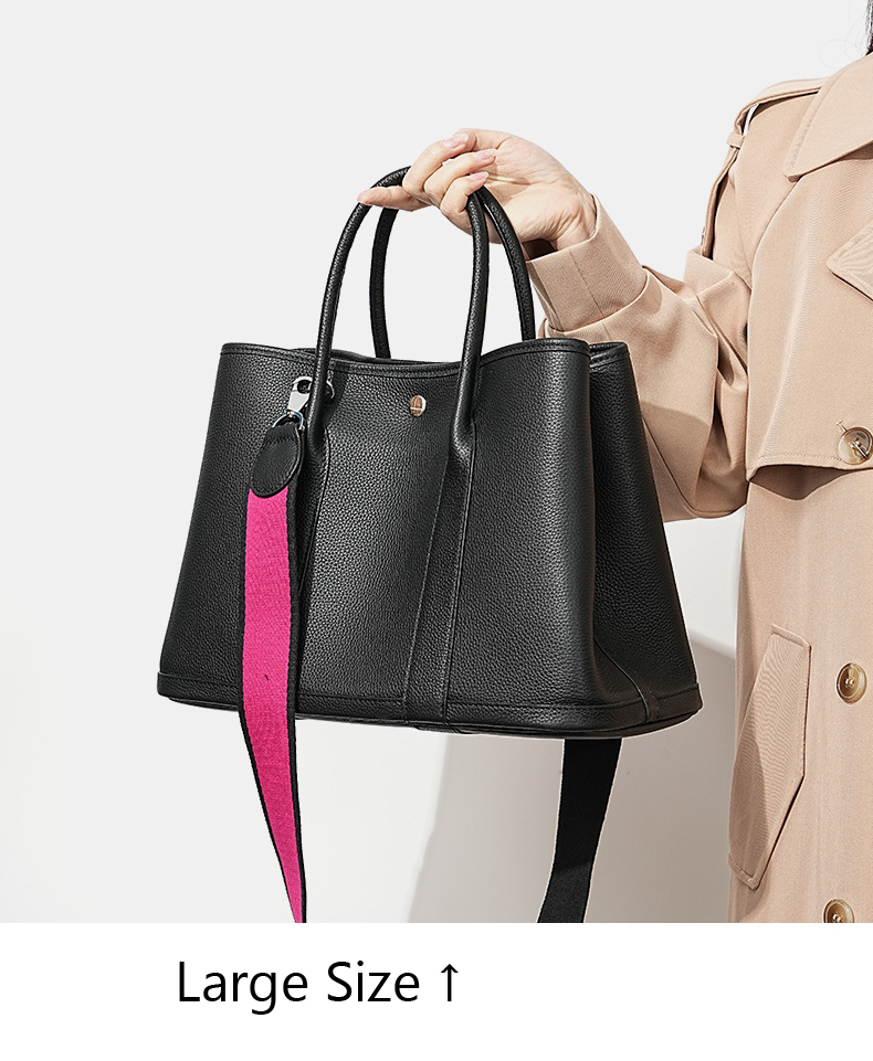 Model carrying a large Premium Togo Leather Structured Tote Bag in Black