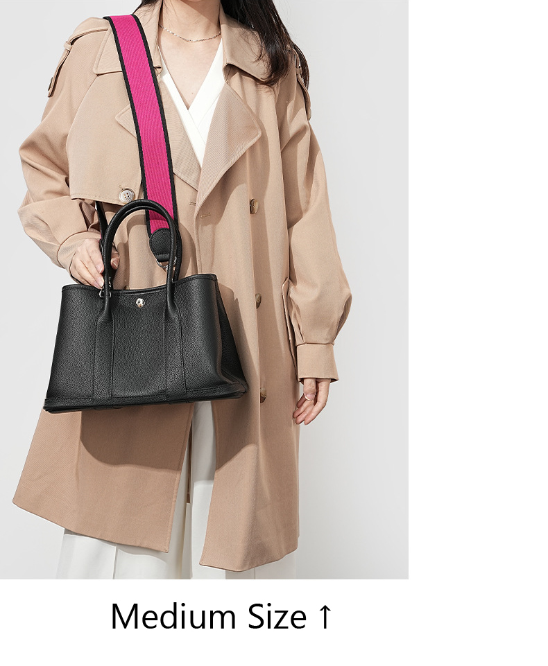Model carrying a medium Premium Togo Leather Structured Tote Bag in Black