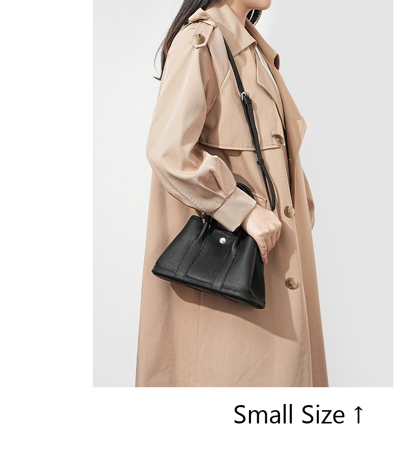 Model carrying a small Premium Togo Leather Structured Tote Bag in Black