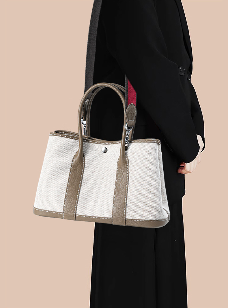 Model carrying Premium Genuine Leather and Canvas Structured Tote Bag in Khaki