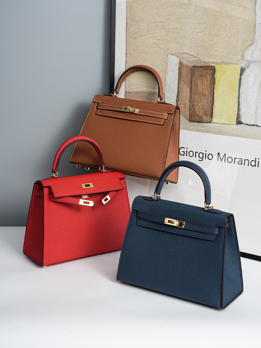 Lifestyle shot of Premium Genuine Leather Structured Top Handle Bags in Royal Blue, Bright Red, and Golden Brown