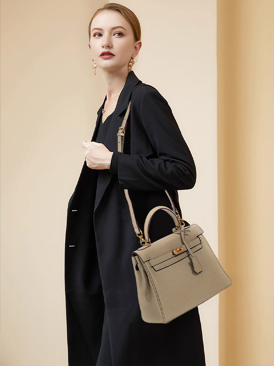 Model carrying Premium Togo Leather Structured Top Handle Bag in Khaki