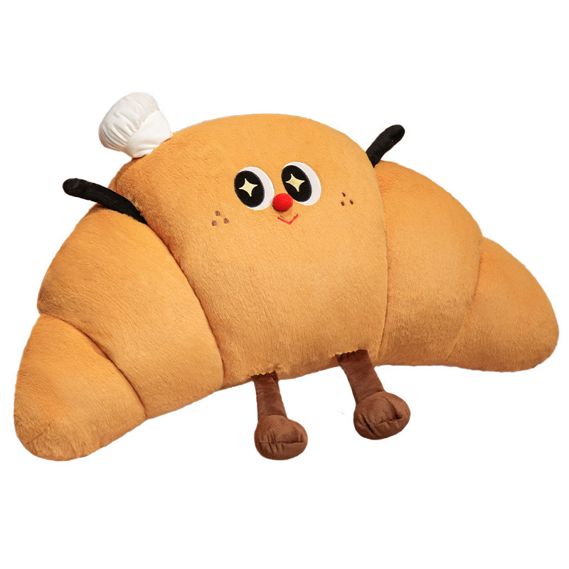 Croissant plush pillow with cute smiling face design, soft croissant-shaped cushion made from plush fabric with fluffy PP cotton filling