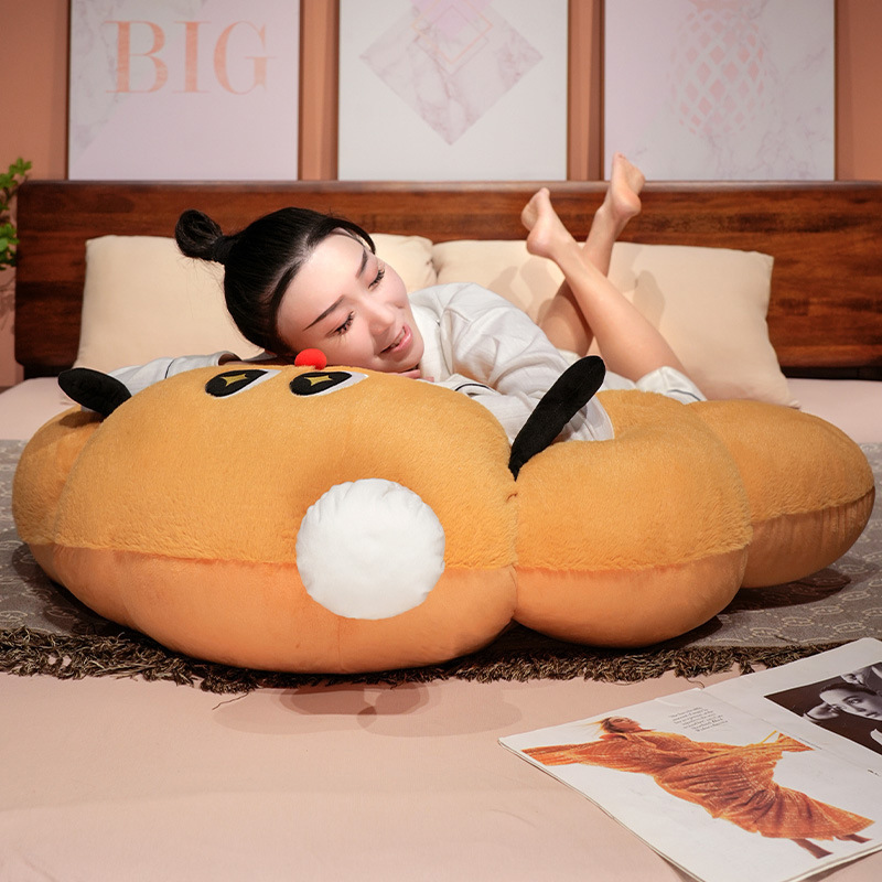 Croissant plush pillow used as a soft lounging and resting cushion, croissant-shaped pillow for comfortable bed relaxation