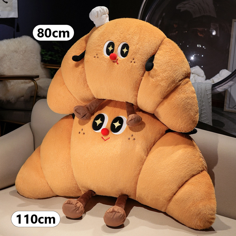 Croissant plush pillow size comparison showing 80 cm and 110 cm croissant-shaped cushions with soft plush fabric and cute face design