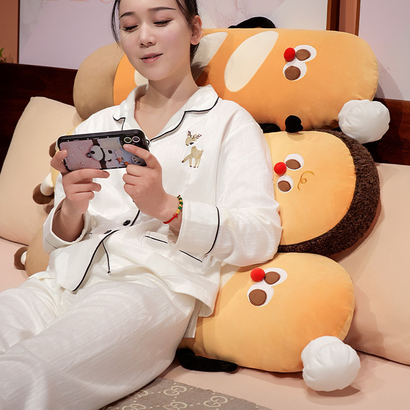 Baguette long plush pillow used as a soft back cushion on a sofa, featuring cute bread design and plush fabric for relaxing and lounging comfort