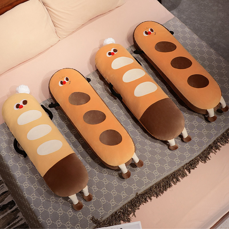 Baguette long plush pillows in chef hat and curly hair styles displayed on a bed, cute bread-shaped body cushions for hugging and cozy decor
