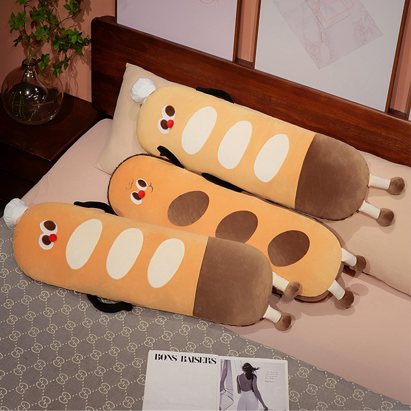 Baguette long plush pillow used as a cozy body cushion on a bed, soft bread-shaped plush pillow ideal for hugging, lounging, and bedroom decor
