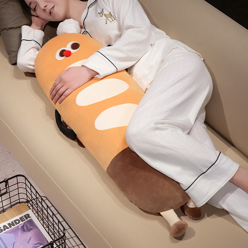 Baguette long plush pillow used as a soft body pillow on a sofa, cute bread-shaped cushion ideal for hugging, lounging, and relaxing comfort