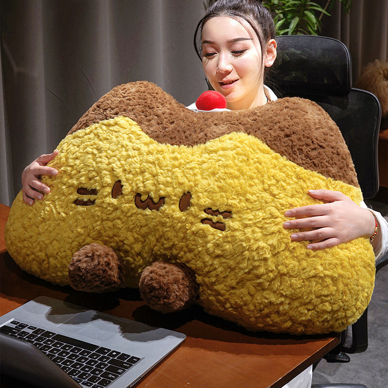 Pudding cat plush backrest pillow used as a cozy cushion while using a laptop, fluffy pudding cat pillow providing comfortable back and arm support