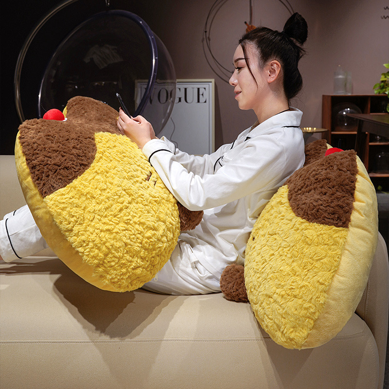 Pudding cat plush backrest pillow used as a soft cushion for lounging, fluffy pudding cat pillow supporting the back while relaxing on a sofa