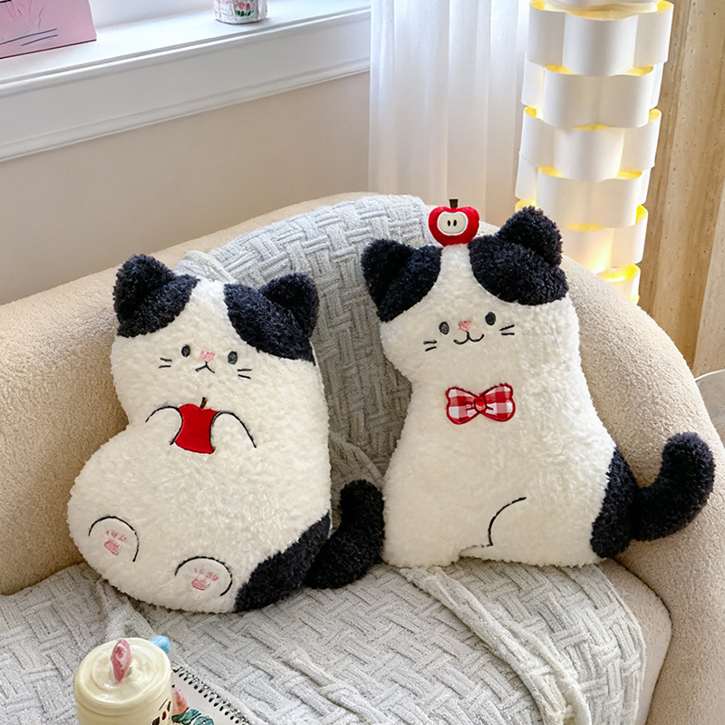 Apple cat plush pillows in sitting and on back styles with apple details displayed on a cozy sofa, soft plush cat cushions for home decor