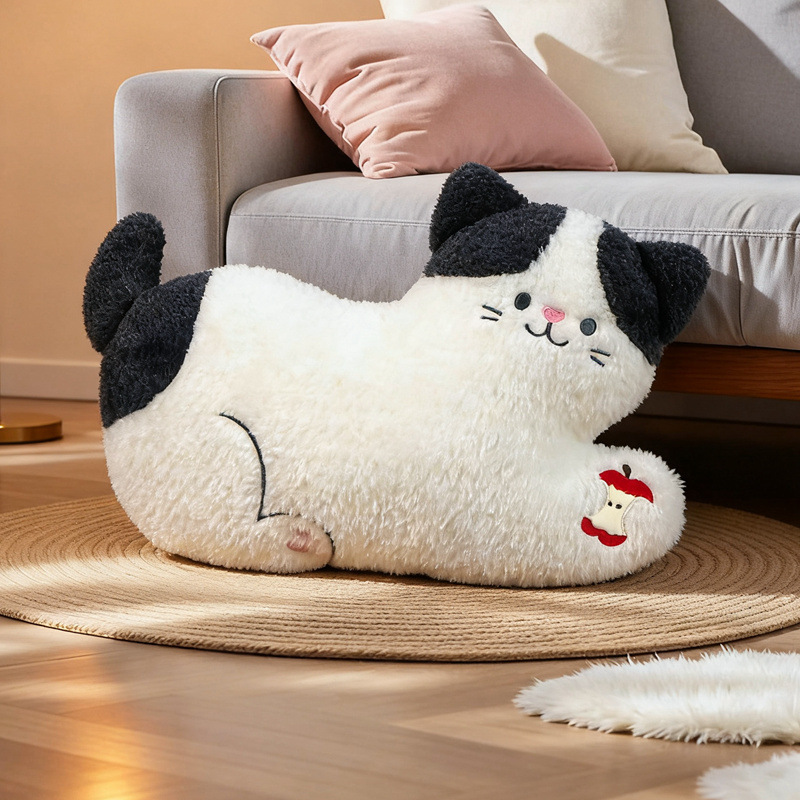 Apple cat plush pillow lying style soft cat cushion with apple detail placed on a cozy rug beside a sofa, cute plush pillow for relaxing home decor