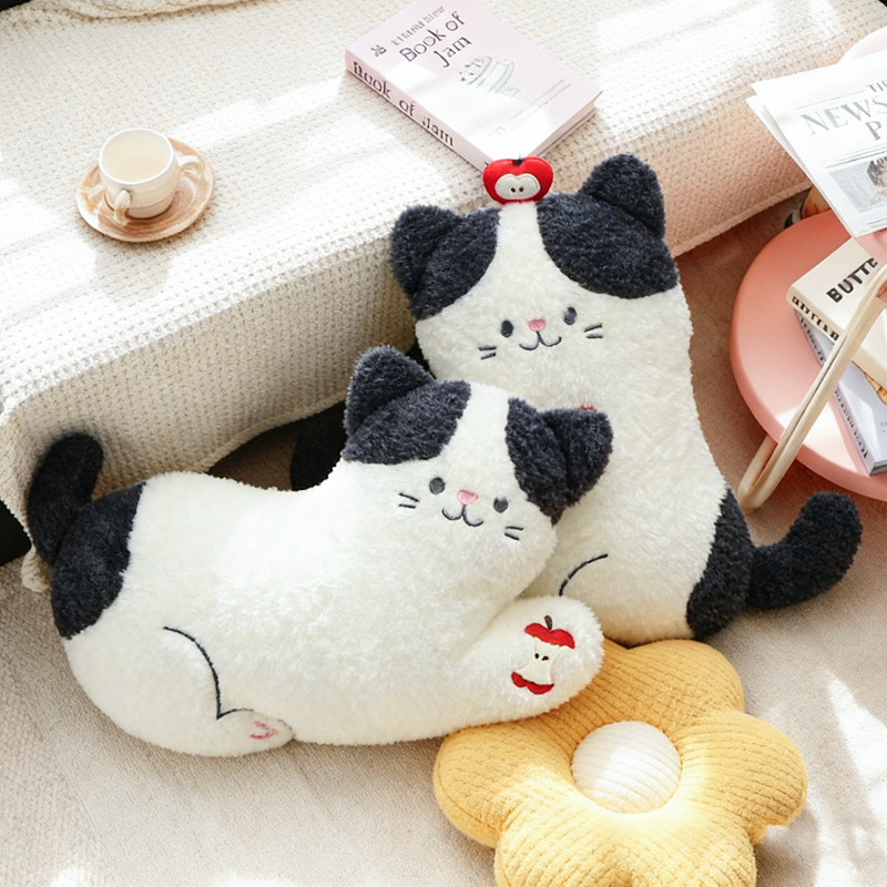 Apple cat plush pillows in lying and sitting styles with apple details, soft cat cushions displayed in a cozy living room setting